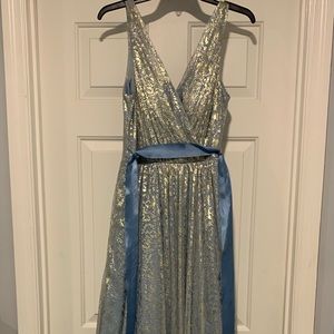 Never worn formal gown. Soft blue covered in a gold lace with a soft blue belt.